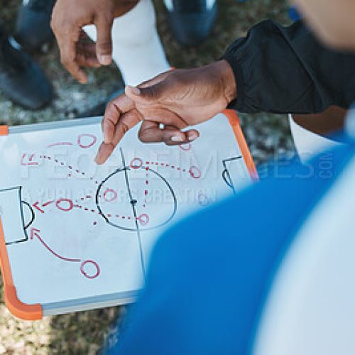 2710974-hands-soccer-team-or-coach-planning-a-strategy-with-tactics-or-training-formation-on-sports-field.-board-fitness-or-closeup-of-manager-teaching-football-players-a-game-plan-for-matc